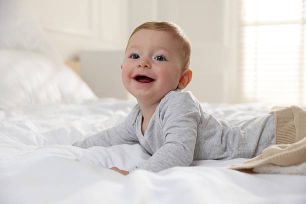 istock Cute little baby on bed at home 2226911521