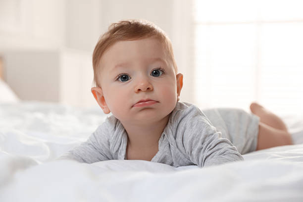 istock Cute little baby on bed at home 2226911539