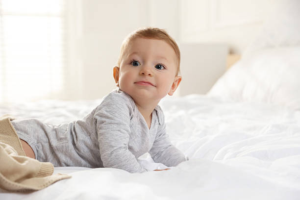 istock Cute little baby on bed at home 2226911541