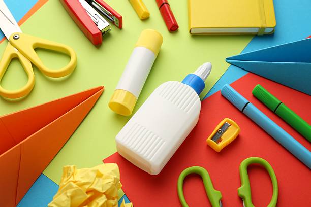 istock Glue, scissors and other stationery on color background, above view 2226911705