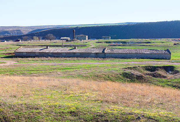 istock Farm buildings stand against rolling hills 2226912419