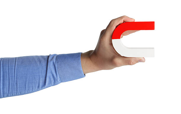istock Man with horseshoe magnet on white background, closeup 2226912830
