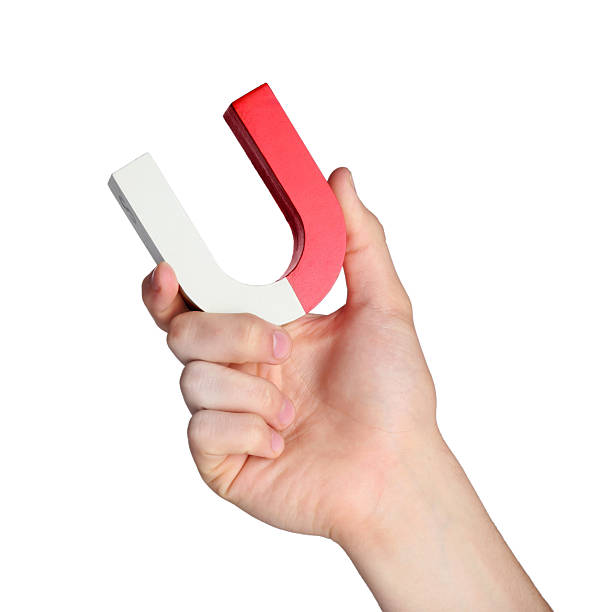 istock Man with horseshoe magnet on white background, closeup 2226912909
