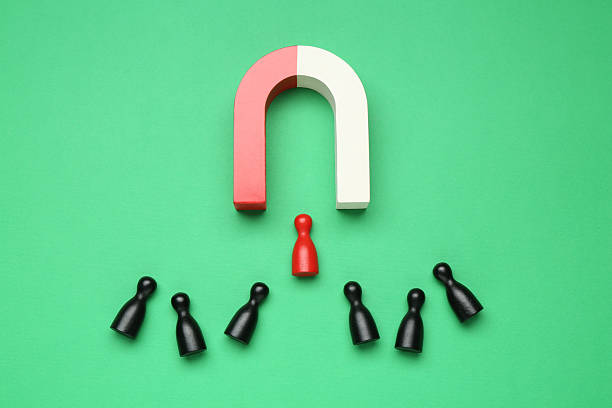 istock Magnet attracting human figures on green background, flat lay 2226912973