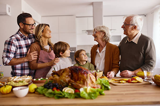 istock Happy extended family talking on Thanksgiving in the kitchen. 2226913227