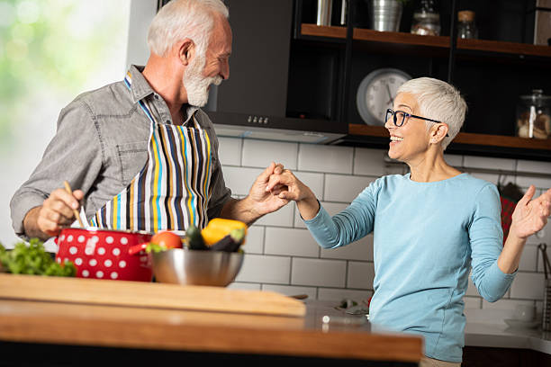 istock Beautiful playful senior couple in kitchen 2226913308