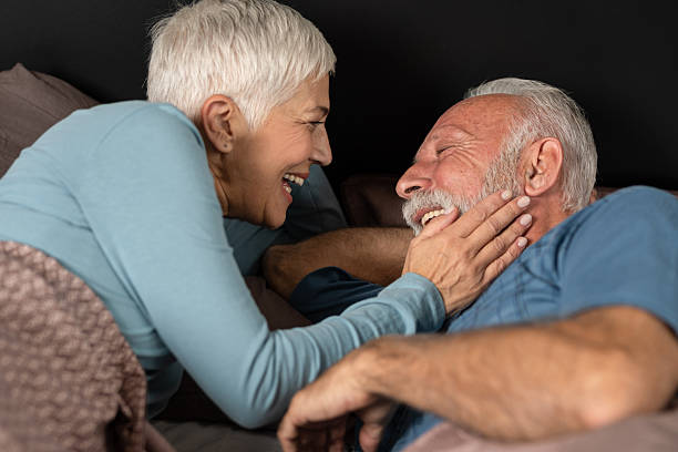 istock Senior couple smiling at each other in bed 2226914209