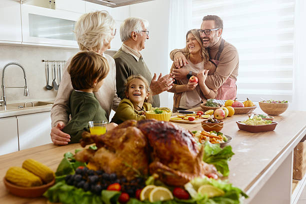 istock Happy extended family talking on Thanksgiving at kitchen counter. 2226914212