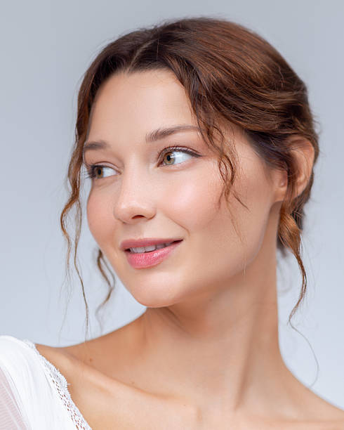 istock Smiling Woman With Radiant Complexion Looking to the Side 2226914978