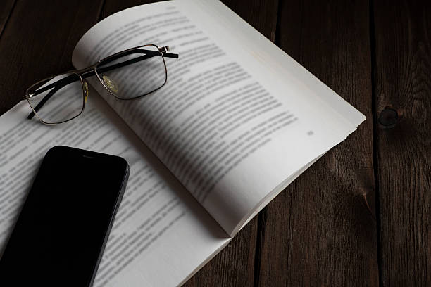 istock Balancing Focus: Book, Phone, and Glasses Still Life 2226917408
