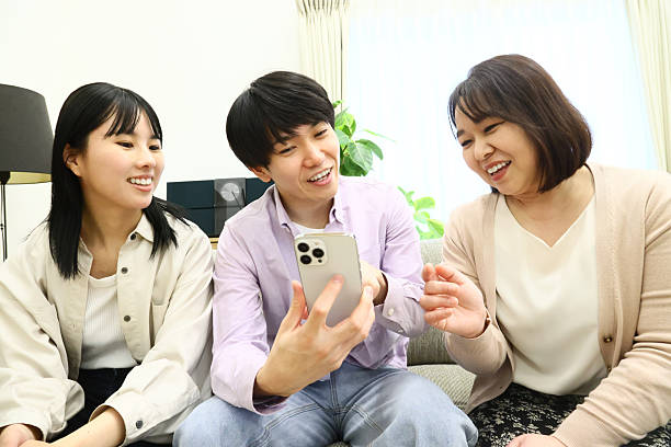 istock Family operating smartphones on the sofa 2226920500
