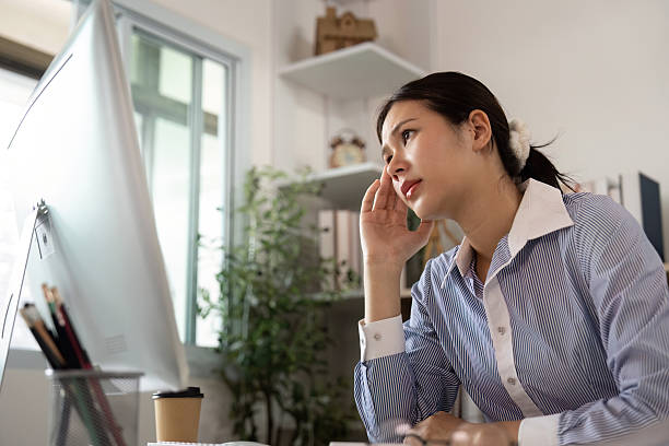 istock Office Syndrome: Young woman contemplating while working at her desk 2226921816
