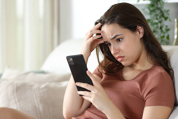 istock Worried woman checking mobile phone complaining in a house 2226922421