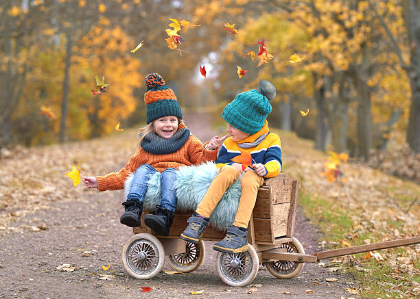 istock Autumn Bliss: Laughing Children Amid Vibrant Fall Colors 2226924410