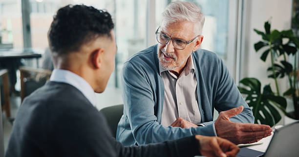 istock Question, senior man or financial advisor talking with laptop, retirement fund or pension info in conversation. Elderly client, office and people in meeting planning for future, advice or consulting 2226926891