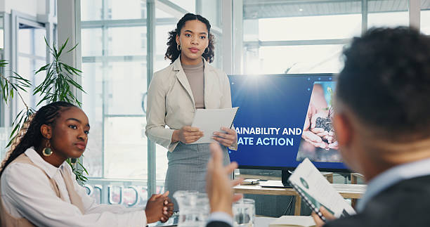 istock Woman, presentation and sustainability at meeting by screen, listen or problem solving for global warming. Person, speaker and audience with documents, question or action for climate change at office 2226926896