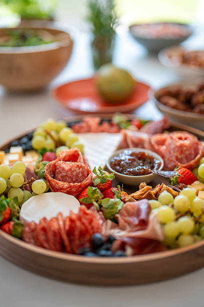 Colorful Charcuterie Board with Fresh Fruits and Meats on a Kitchen Counter
