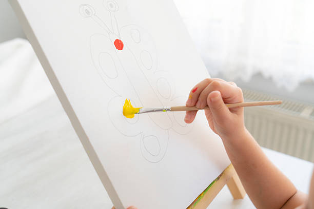 Young artist paints on canvas