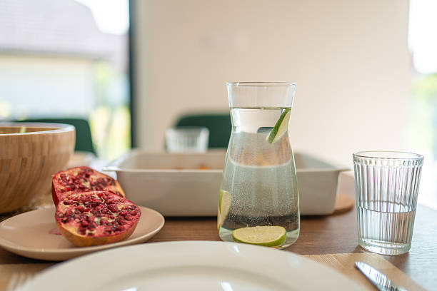 istock Elegant Table Setting With Infused Water Carafe And Fresh Pomegranate 2226929998