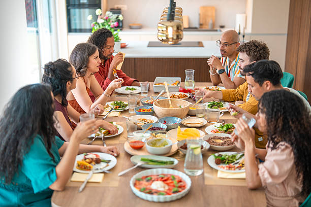 istock Joyful Diverse Group Enjoying Dinner Party with Vibrant Feast at Modern Table Setting 2226930007