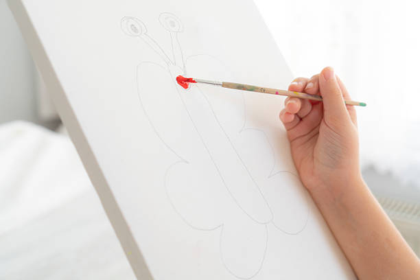 Young artist paints on canvas