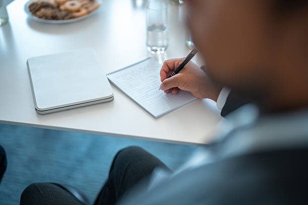 istock Mid-Aged Professional Writing Notes At White Office Desk During Business Meeting 2226935440