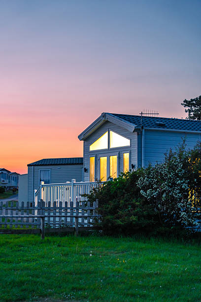 Tranquil sunset illuminates a caravan park in dorset, england, offering a serene vacation setting