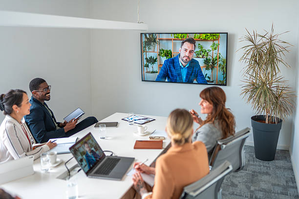 istock Diverse Business Executives Engaged in Video Conference in Modern Boardroom 2226937776