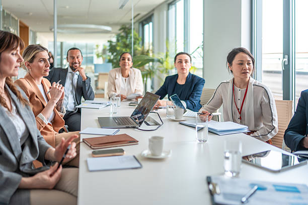 istock Diverse Business Executives Collaborating in Modern Office with Bright Lighting and Glass Walls 2226937803