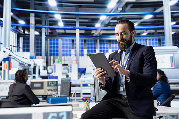 istock Solar panels plant manager pleased by high production, tracking with tablet 2226938016