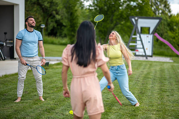 istock Energetic Friends Playing Casual Badminton Game In Summer Backyard Setting 2226938150