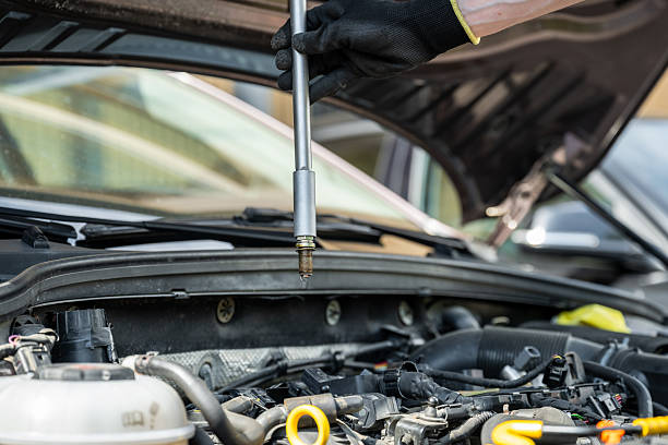 istock Used spark plug held by mechanic in glove during car engine maintenance 2226938961