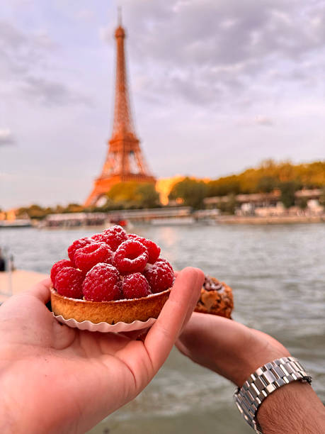 istock A romantic picnic by the river with a view of the Eiffel Tower, featuring raspberry pastries 2226940393