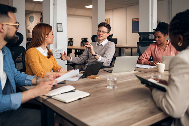 Multiethnic Team Engaged in Discussion During Office Meeting