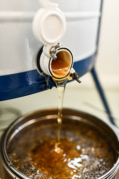 istock Thick Honey Flowing Smoothly From Extraction Tap Into Collection Filter 2226948158