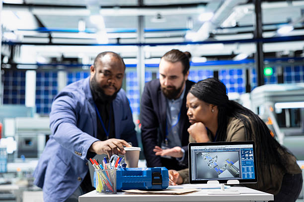 istock Multiethnic master engineers group examining solar panels production in factory 2226948824
