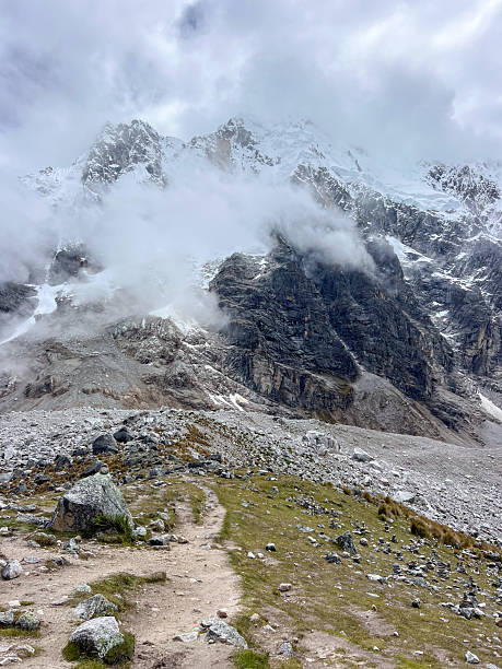 istock Rocky Mountain Trail with Snowy Peaks and Clouds 2226950599