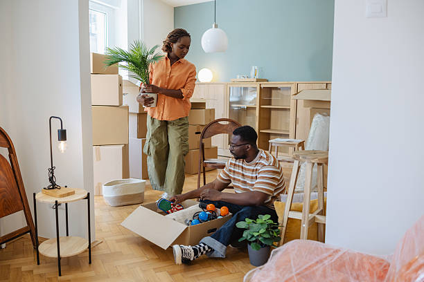 istock Couple unpacking boxes and arranging items in their new home 2226951283
