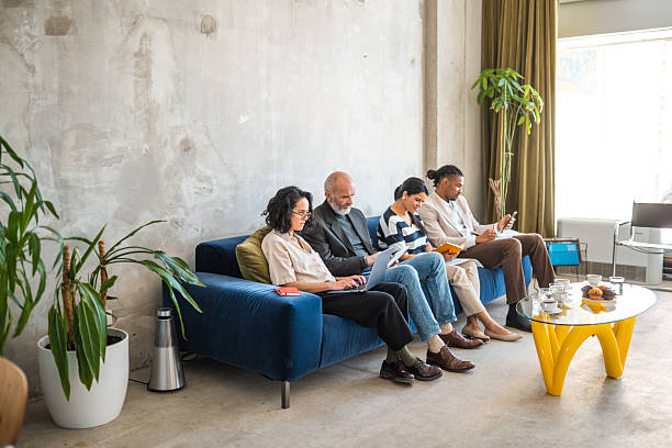 istock Diverse Team Relaxing On Blue Sofa In Modern Industrial Office Space With Plants 2226951614