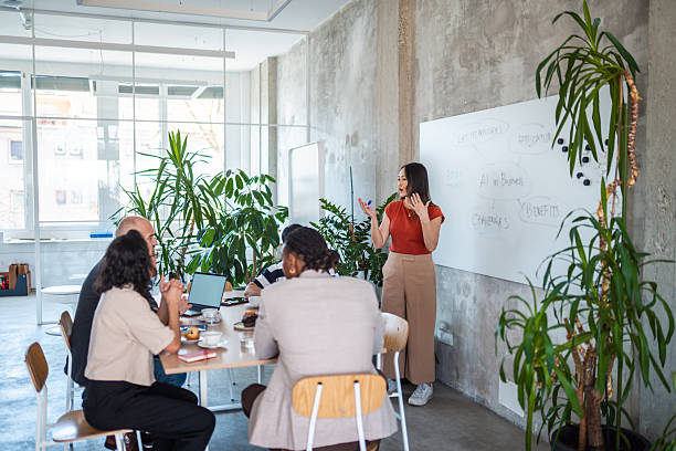 istock Diverse Business Team Collaborating in Modern Office with Whiteboard and Lush Green Plants 2226951649