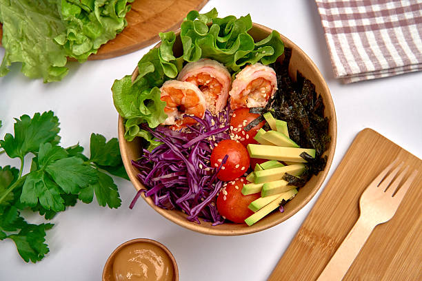 A Delicious Bowl of Fresh Ingredients Featuring Shrimp, Lettuce, Avocado, Radish, and Vibrant Vegetables for a Healthy Meal