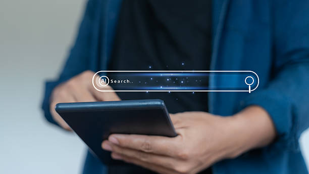 istock Close-up of hands using a tablet with an AI search bar interface, representing artificial intelligence, smart search engine, and digital information technology. 2226952011