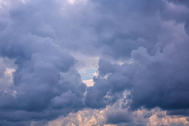 istock Dark gray-blue clouds swirling in the sky with a sky opening between them, inside clouds high in the sky, dark clouds in the sky, cloudy weather, cloudy background. 2226952966