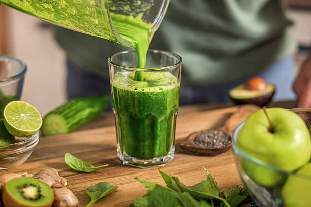 istock Pouring Fresh Green Smoothie Into Glass 2226953725