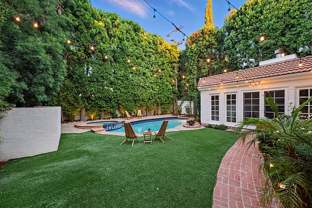istock Storybook Traditional with Lush Backyard, Pool, Spa, and String Lights 2226954741