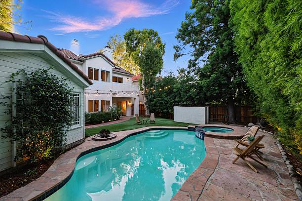 istock Storybook Traditional with Lush Backyard, Pool, Spa, and String Lights 2226954749