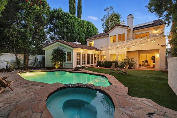 istock Storybook Traditional with Lush Backyard, Pool, Spa, and String Lights 2226954778