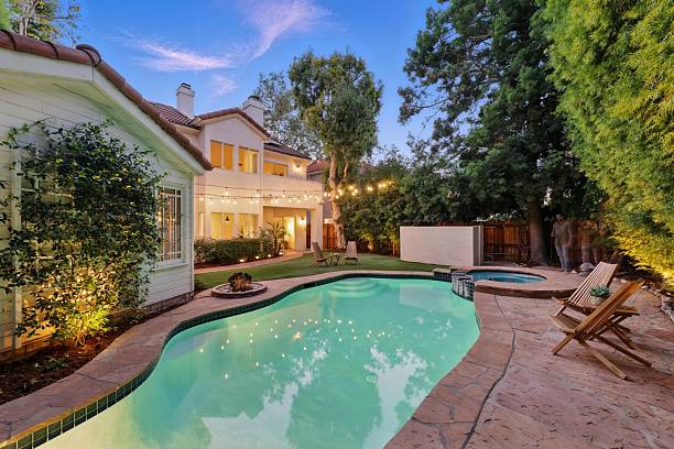 istock Storybook Traditional with Lush Backyard, Pool, Spa, and String Lights 2226954783