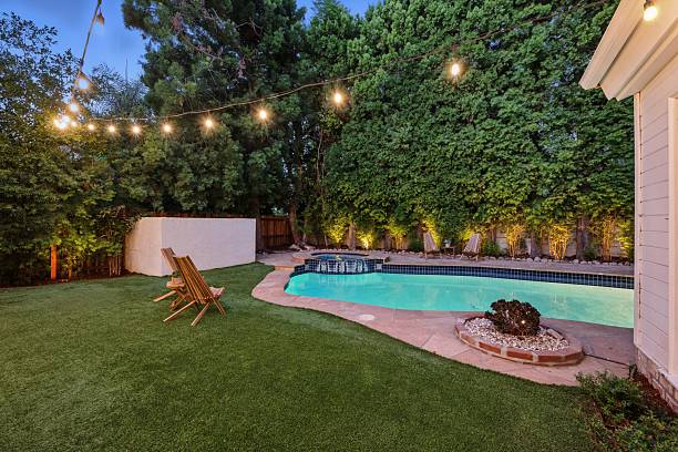 istock Storybook Traditional with Lush Backyard, Pool, Spa, and String Lights 2226954786