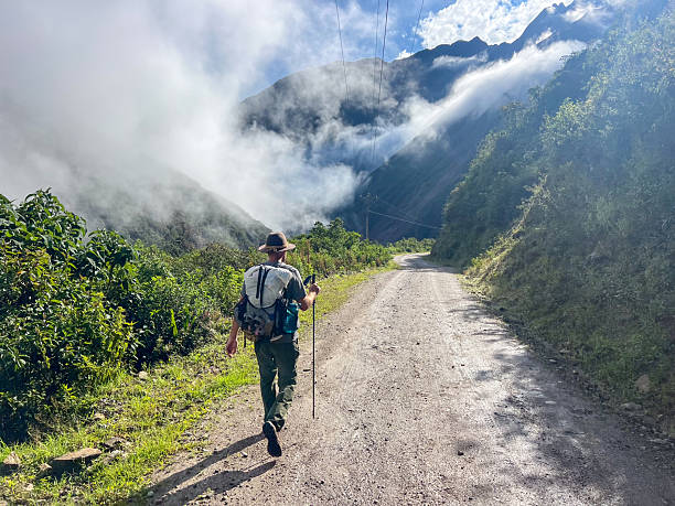istock Hiker Walking on Mountain Trail with Fog 2226955494